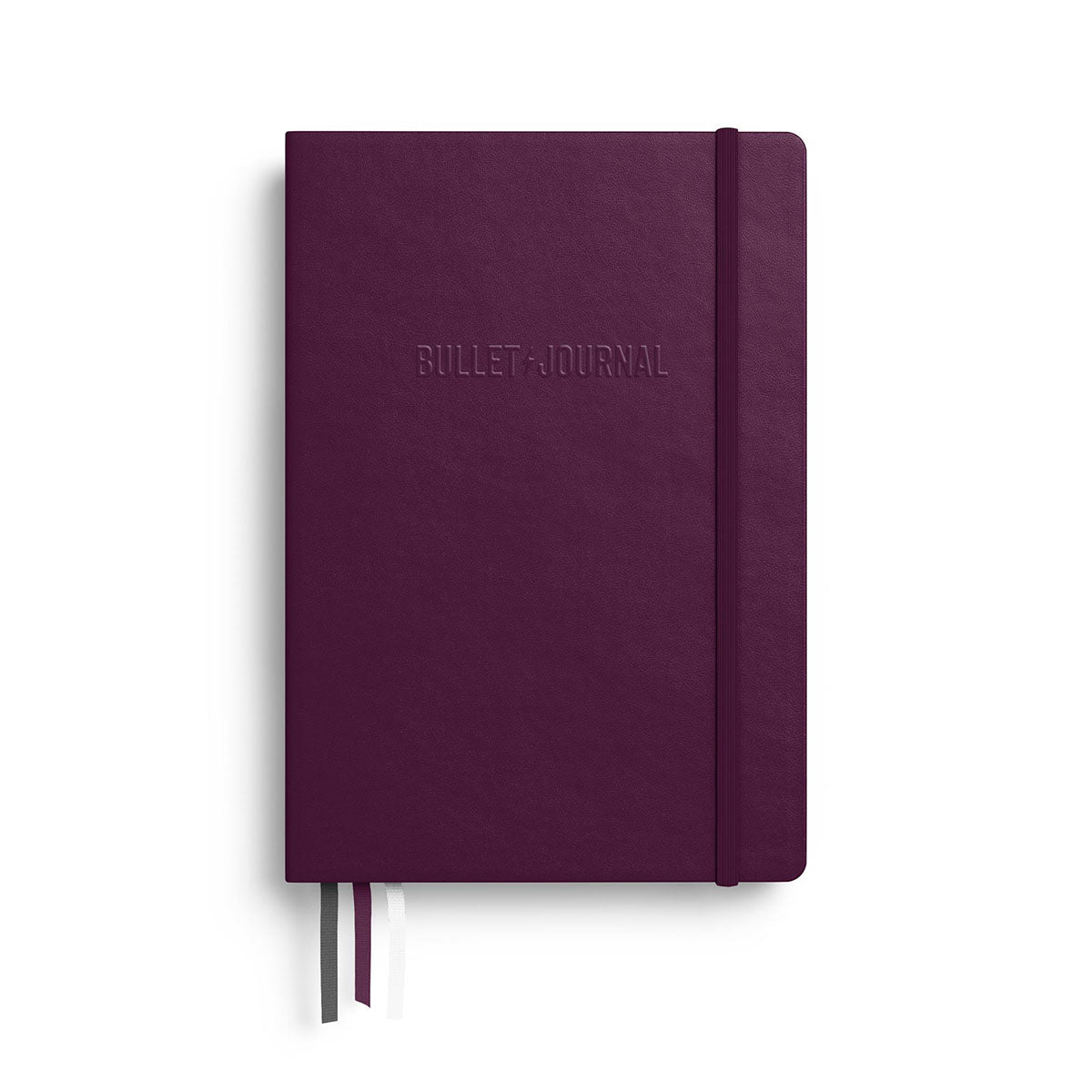Przednia okładka notatnika z napisem Bullet Journal i trzema materiałowymi tasiemkami.
